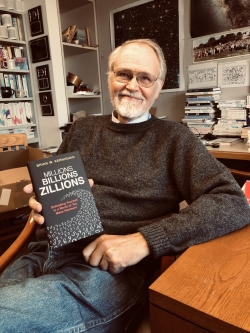 Brian Kernighan holding his copy of his new book "Millions, Billions, Zillions: Defending Yourself in a World of Too Many Numbers"