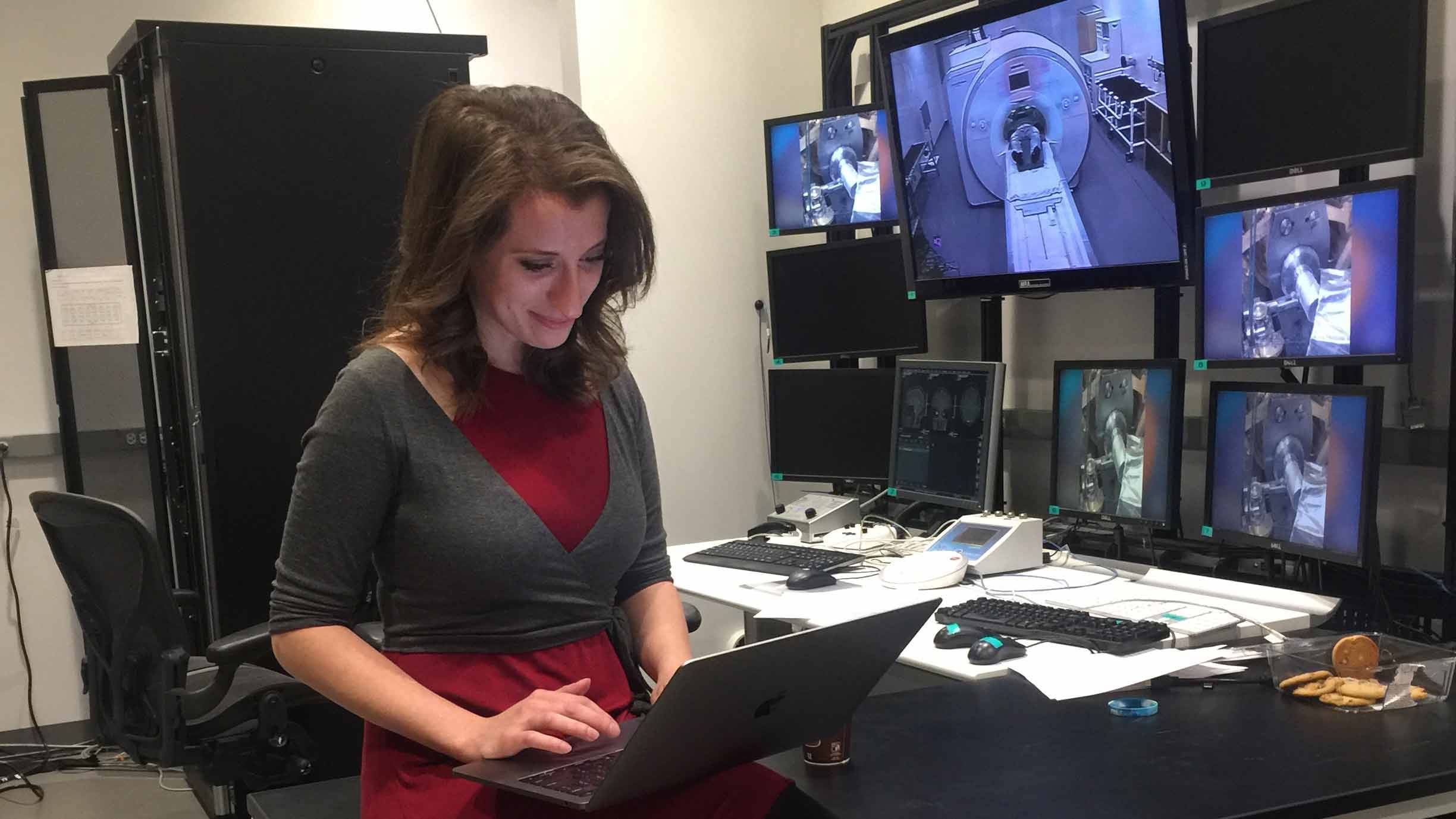 Hanna Hillman sits in the fMRI control room as she prepares to scan one of the students.